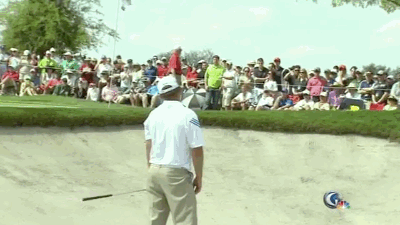 J.B. Holmes takes out some frustration on a bunker.
