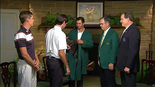 Bubba Watson gets the green jacket from Adam Scott.