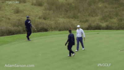 Rose and his caddie with the high five fail.