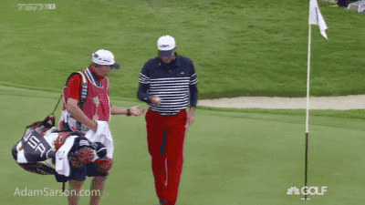 Kuchar signs a ball mid match for a fan.