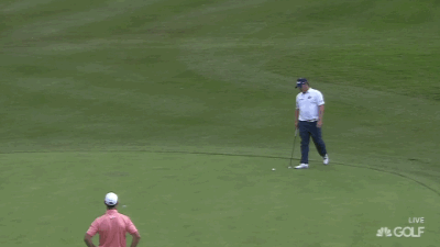 The second ball to be hit into the green while George Coetzee is trying to putt.